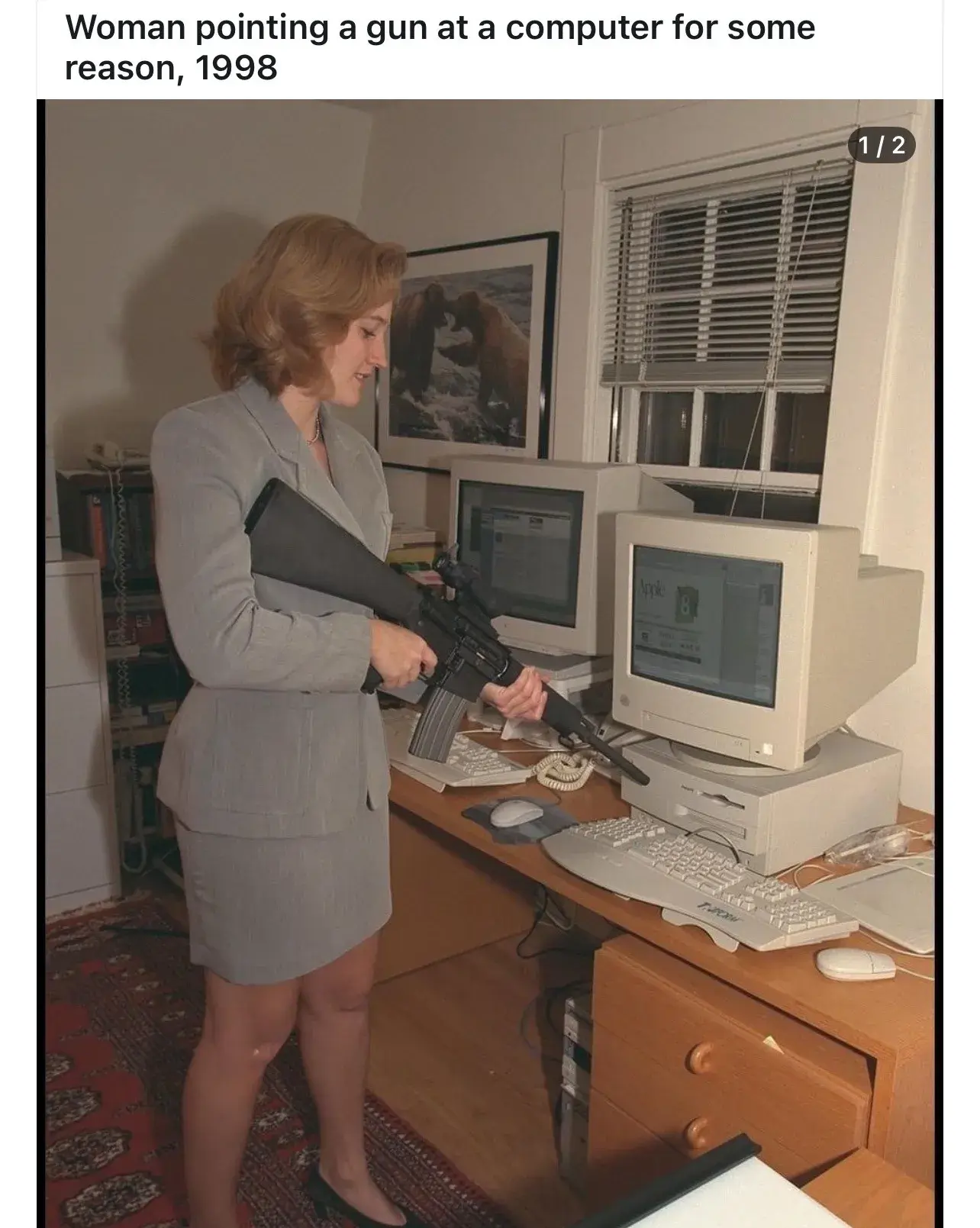 A picture of a woman pointing an assault rifle at a computer for some reason, with the caption at the top saying "Woman pointing a gun at a computer for some reason, 1998"